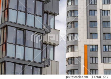 Modern architecture harmonizes with the sky in a lively urban setting showcasing unique building designs Modern architecture harmonizes with the sky in a lively urban setting showcasing unique building designs 142681857