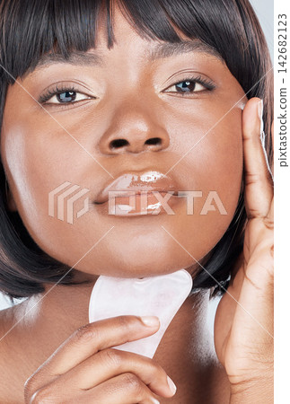 Gua Sha, beauty and black woman portrait with cosmetics, skincare and dermatology in studio. Wellness, youth serum and rose quartz with facial massage, skin glow and care with calm from treatment Gua Sha, beauty and black woman portrait with cosmetics, skincare and dermatology in studio. Wellness, youth serum and rose quartz with facial massage, skin glow and care with calm from treatment 142682123