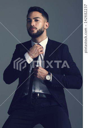 Confident businessman, portrait and fashion with suit in formal attire or clothing on a dark studio background. Handsome man, young employee or model with stylish outfit, tie and ready for business Confident businessman, portrait and fashion with suit in formal attire or clothing on a dark studio background. Handsome man, young employee or model with stylish outfit, tie and ready for business 142682237