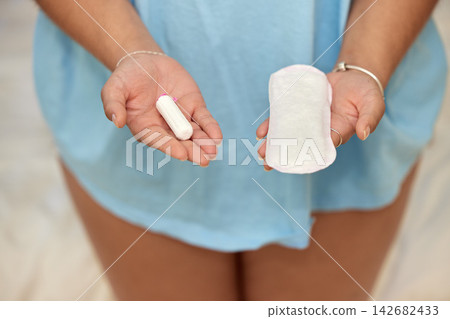 Woman, hands and sanitary towel or tampon for period, choice and option for wellness product and comfort. Absorb, menstruation and healthcare with female person in home, gynecology tested for hygiene Woman, hands and sanitary towel or tampon for period, choice and option for wellness product and comfort. Absorb, menstruation and healthcare with female person in home, gynecology tested for hygiene 142682433