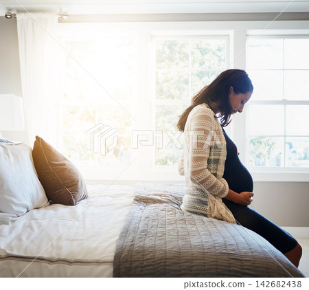 Home, excited and pregnant woman with sunshine, relax and rest with fertility, stomach and belly. Person, bedroom and girl with pregnancy, motherhood and joy with maternity leave, wellness and health Home, excited and pregnant woman with sunshine, relax and rest with fertility, stomach and belly. Person, bedroom and girl with pregnancy, motherhood and joy with maternity leave, wellness and health 142682438
