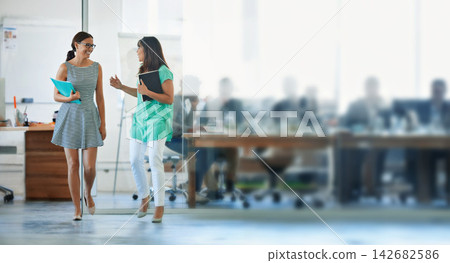 Creative, woman and walking with discussion in office building for collaboration on designer project for agency. Colleagues, talking and together for partnership or friendship in workplace and ideas. Creative, woman and walking with discussion in office building for collaboration on designer project for agency. Colleagues, talking and together for partnership or friendship in workplace and ideas. 142682586