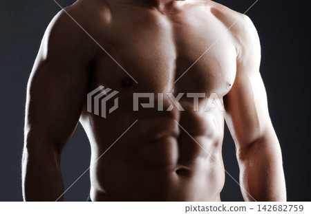 Body, man and fitness with abs in studio for wellness, bodybuilding and strong muscle, health and workout for sports goal. Shirtless, male athlete and results, bodybuilder and exercise for progress 142682759