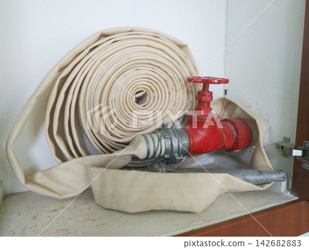 Fire protection cabinet with fire hydrant and hose. It's in the store Fire protection cabinet with fire hydrant and hose. It's in the store 142682883