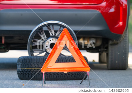 A warning triangle or breakdown triangle on a road. A warning triangle or breakdown triangle on a road. 142682995