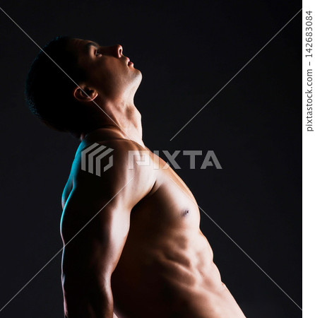 Man, profile and flex muscle in studio for wellness or body builder, strong and dark for power or strength. Person, thinking and mock up with abs, isolated and black background for aesthetic shadow. 142683084