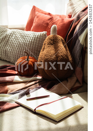 Cozy Autumn Scene With Pumpkins Blankets Notebook And Pen For Seasonal Themes Cozy Autumn Scene With Pumpkins Blankets Notebook And Pen For Seasonal Themes 142683287