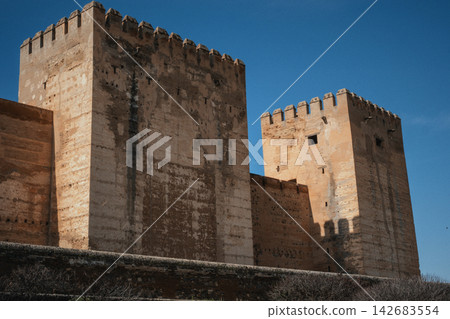 Moorish palatial fortress architecture, looking up at the ancient alcazaba towers in alhambra, granada, spain Moorish palatial fortress architecture, looking up at the ancient alcazaba towers in alhambra, granada, spain 142683554