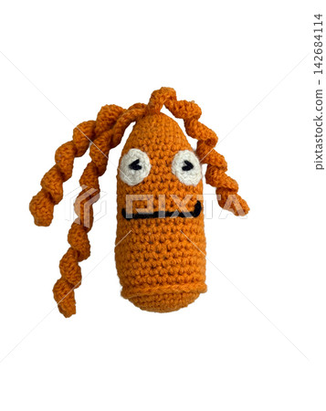 Cute handmade orange crochet creature doll isolated on white background 142684114