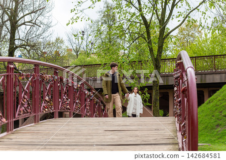 Romantic couple walking on love lock bridge Romantic couple walking on love lock bridge 142684581
