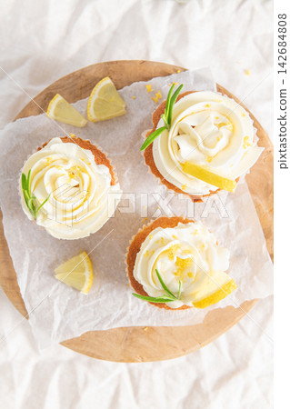 Lemon cupcakes with white frosting from a top view Lemon cupcakes with white frosting from a top view 142684808