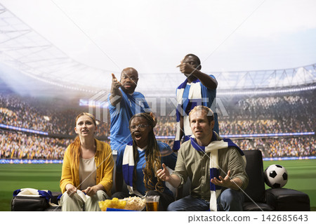 Soccer fans react to tense game on immersive TV broadcast making them feel like being on pitch side. Football supporters watching dramatic match, feeling stadium experience emotions Soccer fans react to tense game on immersive TV broadcast making them feel like being on pitch side. Football supporters watching dramatic match, feeling stadium experience emotions 142685643