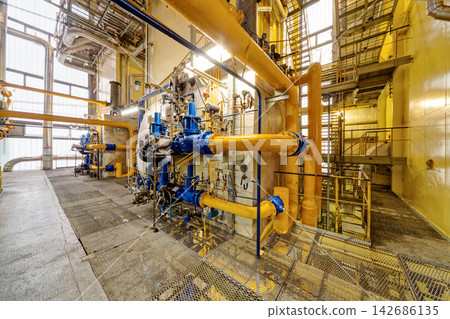 Industrial Plant Interior with Yellow Pipes and Blue Valves Industrial Plant Interior with Yellow Pipes and Blue Valves 142686135