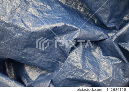 Blue Plastic Tarp Texture Background With Wrinkled Waterproof Fabric Blue Plastic Tarp Texture Background With Wrinkled Waterproof Fabric 142686136