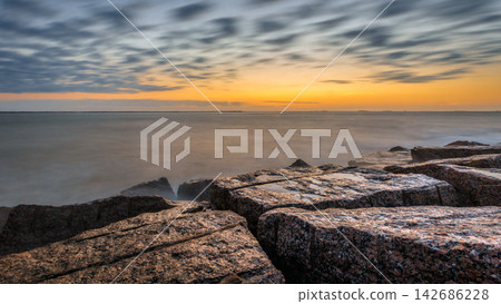 Ocean Sunset Over Rocky Shoreline With Long Exposure Seascape Ocean Sunset Over Rocky Shoreline With Long Exposure Seascape 142686228