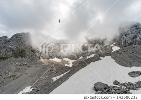 Foggy Alpine Mountain Landscape with Cable Car and Snowfields Foggy Alpine Mountain Landscape with Cable Car and Snowfields 142686232