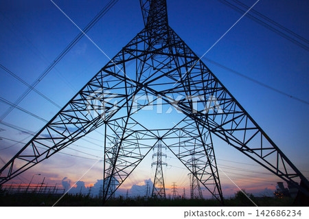 Power Transmission Towers at Sunset with High Voltage Lines Power Transmission Towers at Sunset with High Voltage Lines 142686234