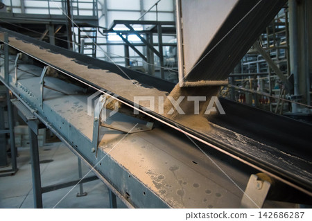 Industrial Conveyor Belt Moving Powder in Manufacturing Plant 142686287