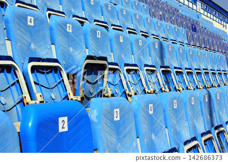 Blue Empty Stadium Seats in Outdoor Sports Arena Blue Empty Stadium Seats in Outdoor Sports Arena 142686373