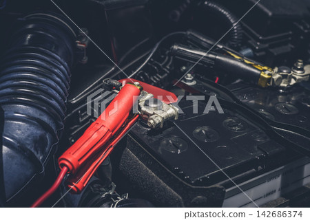 Car Battery Jump Starter Cables in Engine Bay Close-Up Car Battery Jump Starter Cables in Engine Bay Close-Up 142686374