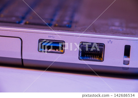 Laptop USB and Ethernet Ports Close Up in Purple Light Laptop USB and Ethernet Ports Close Up in Purple Light 142686534