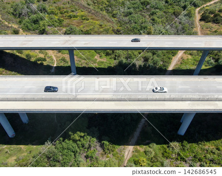 Aerial Highway Bridge with Cars Over Green Landscape Aerial Highway Bridge with Cars Over Green Landscape 142686545