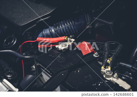 Car Battery Jump Start Cable in Engine Bay Close Up Car Battery Jump Start Cable in Engine Bay Close Up 142686601