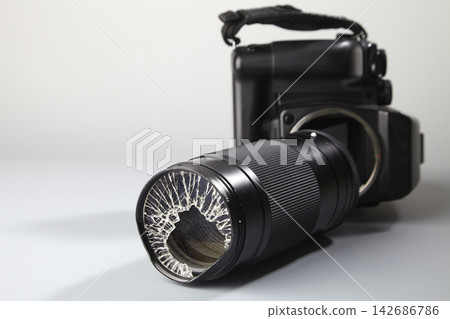 Broken Camera Lens on Black Digital Camera Broken Camera Lens on Black Digital Camera 142686786