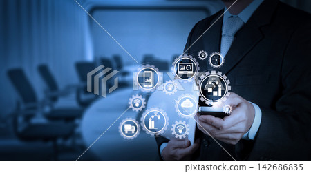Businessman Using Smartphone with Industrial IoT Interface Businessman Using Smartphone with Industrial IoT Interface 142686835