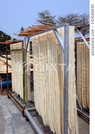 Traditional Noodles Drying on Outdoor Racks in Sunlight Traditional Noodles Drying on Outdoor Racks in Sunlight 142686840
