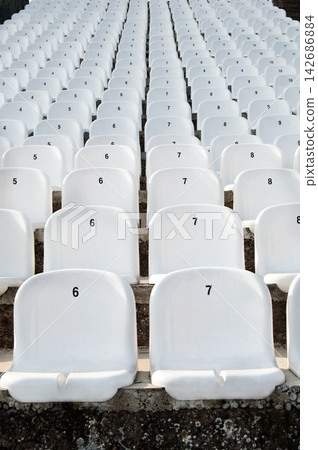 Empty White Stadium Seats in Repeating Rows 142686884