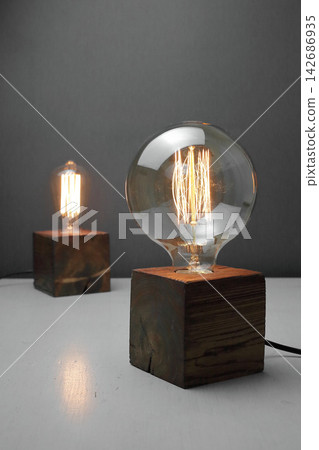 Vintage Edison Light Bulbs on Wooden Bases in Rustic Interior 142686935