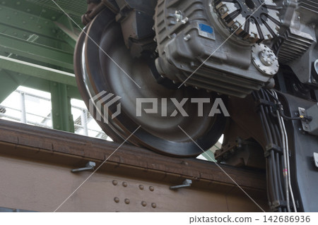 Train Wheel and Mechanical Undercarriage Close-Up on Rail Track Train Wheel and Mechanical Undercarriage Close-Up on Rail Track 142686936