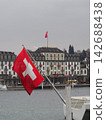 The Swiss flag flies over Lake Lucerne. 142688438
