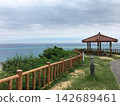 The beautiful ocean and Okinawan red-tiled gazebos as seen from the observation deck on the hill. 142689461
