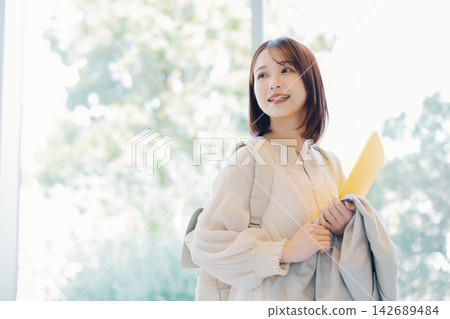 Smiling female college student 142689484