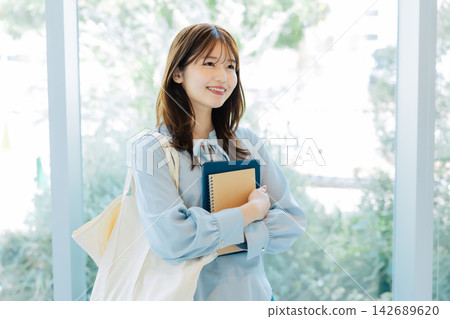 Smiling female college student Smiling female college student 142689620