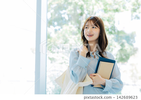 Smiling female college student Smiling female college student 142689623