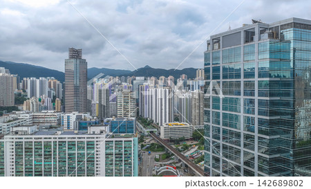Aug 23 2026 Hong Kong Dense urban skyline with glass commercial tower a Aug 23 2026 Hong Kong Dense urban skyline with glass commercial tower a 142689802