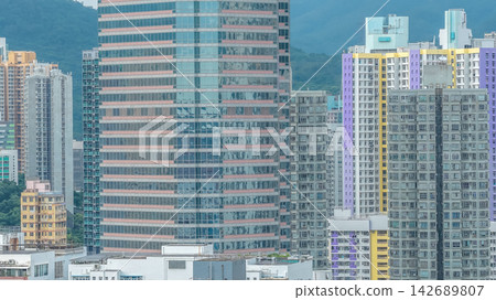 Aug 23 2026 Hong Kong Dense urban skyline with glass commercial tower a Aug 23 2026 Hong Kong Dense urban skyline with glass commercial tower a 142689807