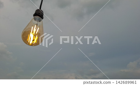 Vintage LED String Light Bulb Glowing at Beach Cafe Vintage LED String Light Bulb Glowing at Beach Cafe 142689961