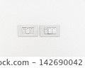 Triple lighting switch on white concrete wall 142690042