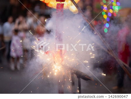 Exploding Chinese Firecrackers with Smoke and Sparks during Lunar New Year Celebration in Old Chinatown Street. Exploding Chinese Firecrackers with Smoke and Sparks during Lunar New Year Celebration in Old Chinatown Street. 142690047