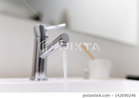 Water flowing from the faucet Water flowing from the faucet 142690246