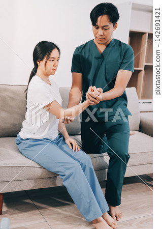 A Modern rehabilitation physiotherapy man at work with woman client A Modern rehabilitation physiotherapy man at work with woman client 142691421
