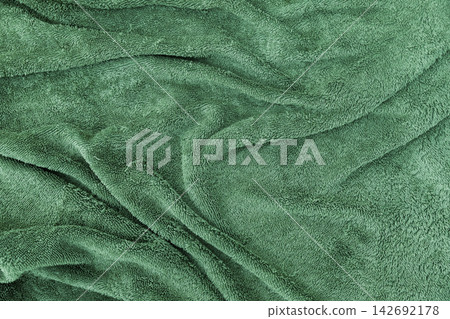 Soft green plush fabric photographed close-up, showing rich pile and gentle folds Soft green plush fabric photographed close-up, showing rich pile and gentle folds 142692178