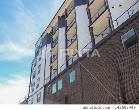 Low-angle view of a modern apartment building with balconies in Ruston, WA. - June 13, 2026 Ruston WA, USA Low-angle view of a modern apartment building with balconies in Ruston, WA. - June 13, 2026 Ruston WA, USA 142692449
