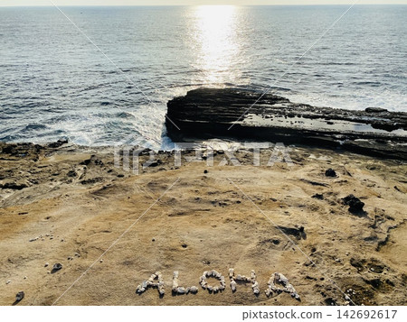 A "thank you" message painted on the beach A "thank you" message painted on the beach 142692617