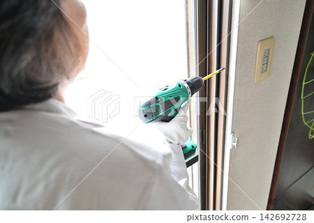 Renovation: Image of workers installing double-glazed windows. 142692728