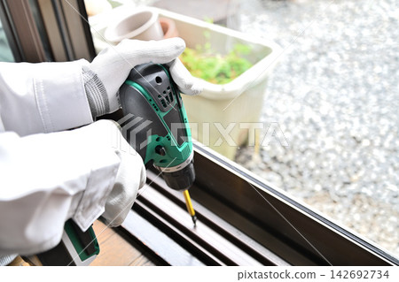 Renovation: Image of workers installing double-glazed windows. Renovation: Image of workers installing double-glazed windows. 142692734